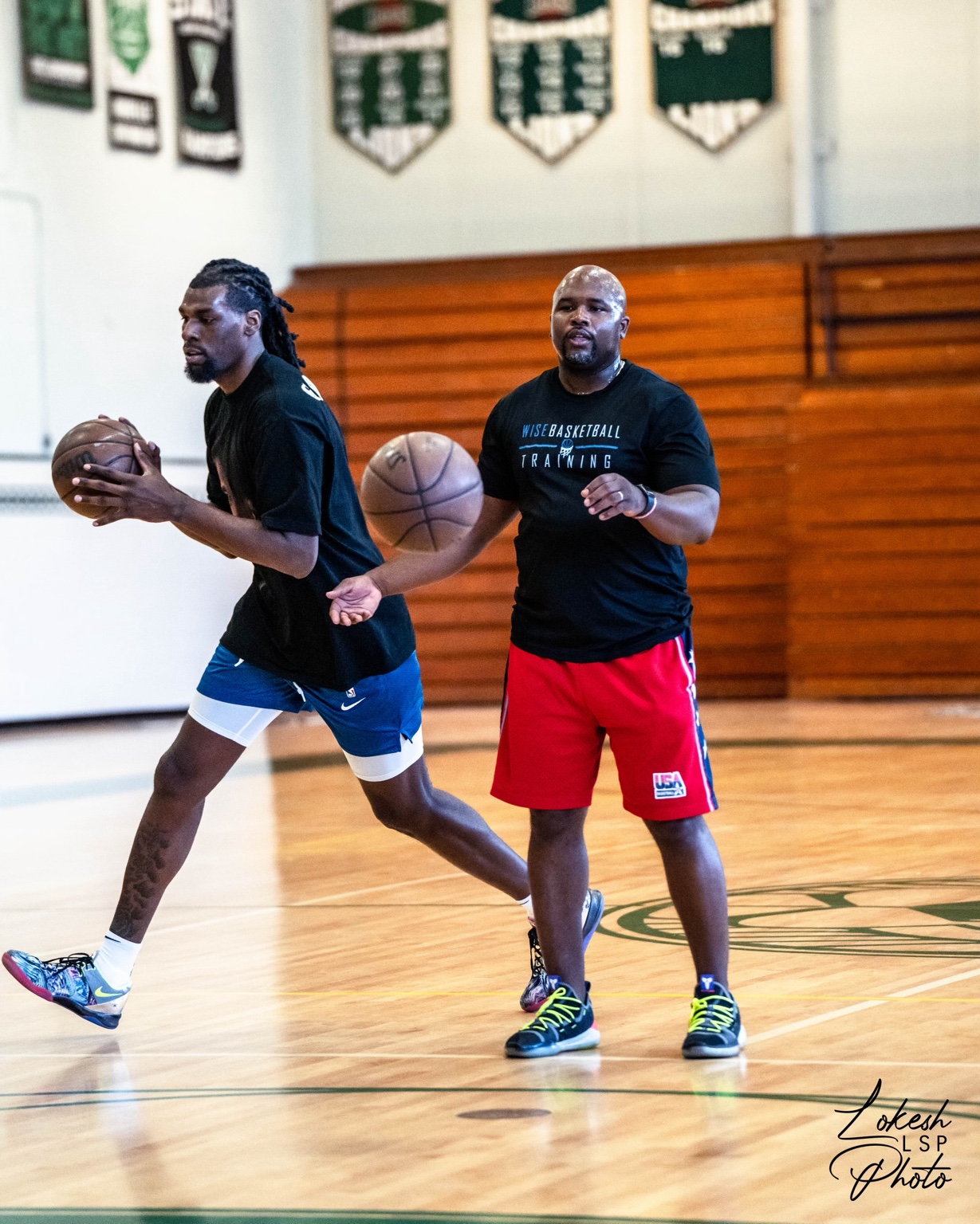 Coach Jamar Wise leading an on-court basketball drill with an athlete